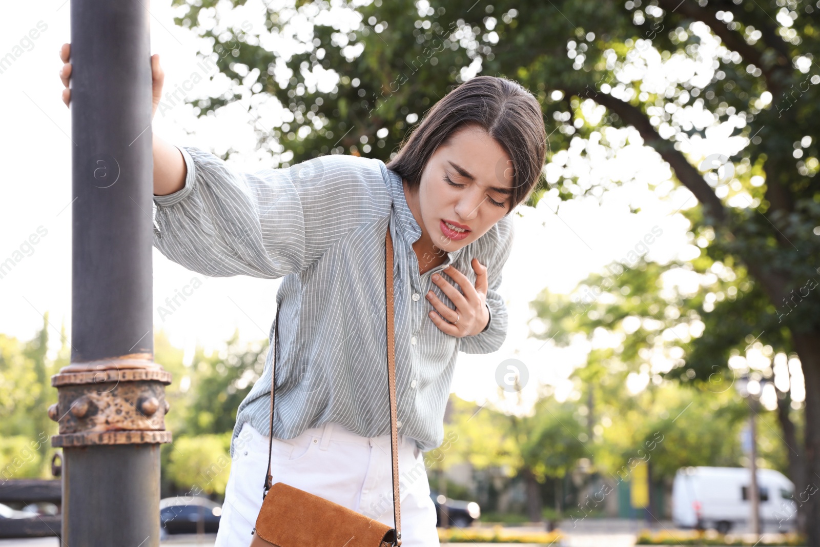 Photo of Young woman having heart attack in park