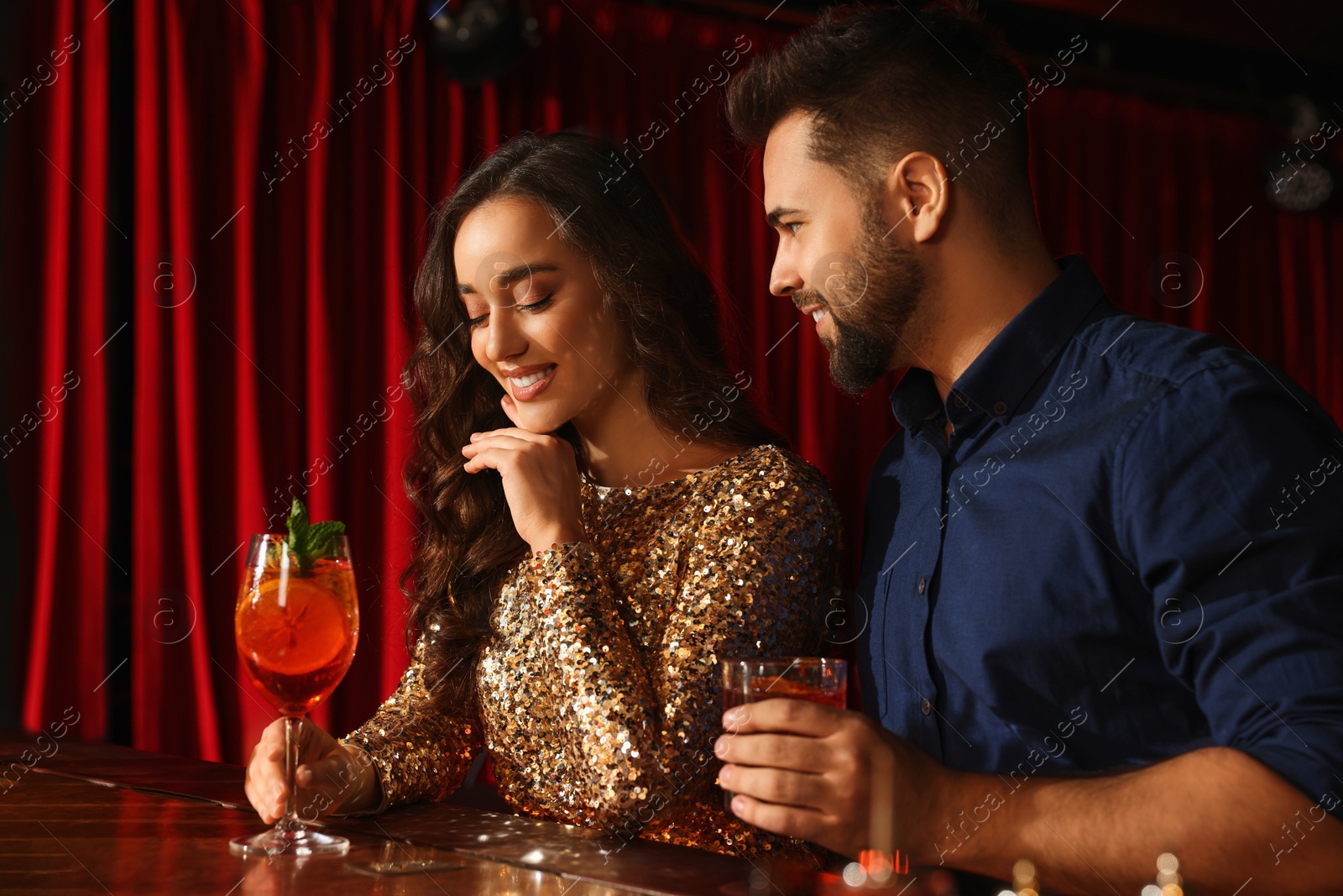 Photo of Lovely couple with fresh cocktails at bar counter