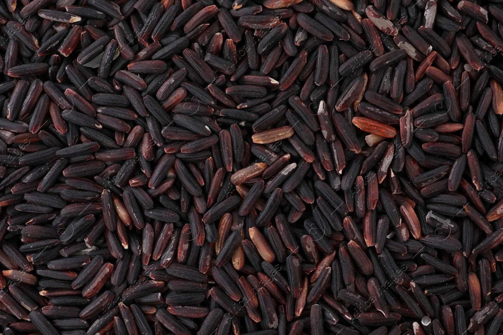 Photo of Raw black rice as background, top view