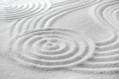 Photo of White sand with pattern as background. Zen, meditation, harmony