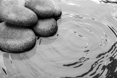 Stones in water, space for text. Zen lifestyle