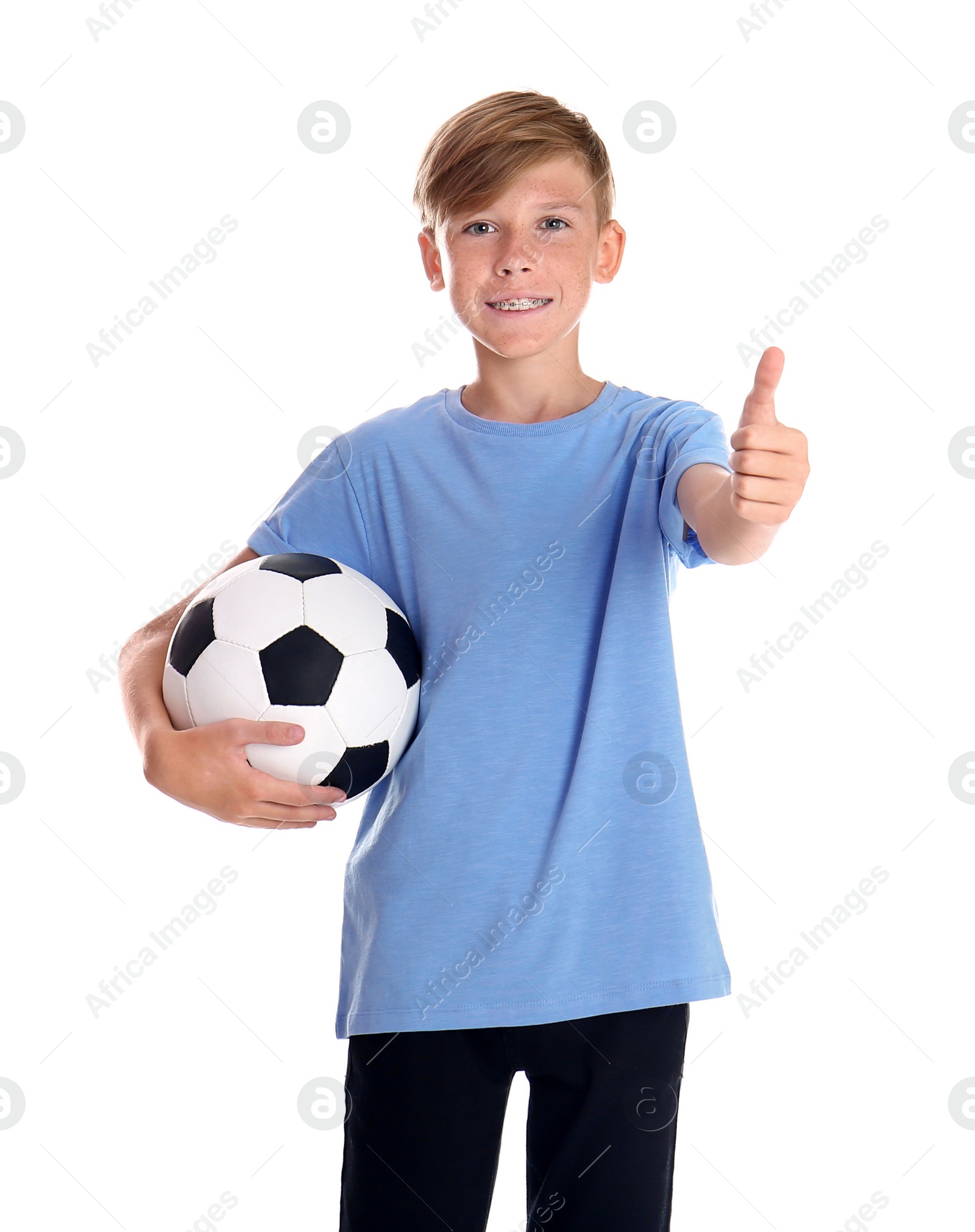 Photo of Portrait of young boy holding soccer ball on white background
