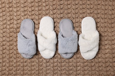Photo of Soft grey and white slippers on carpet, flat lay