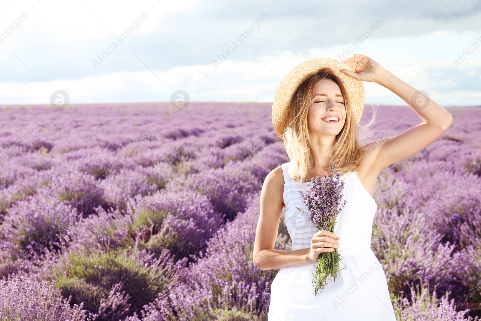 Photo of Young woman with bouquet in lavender field