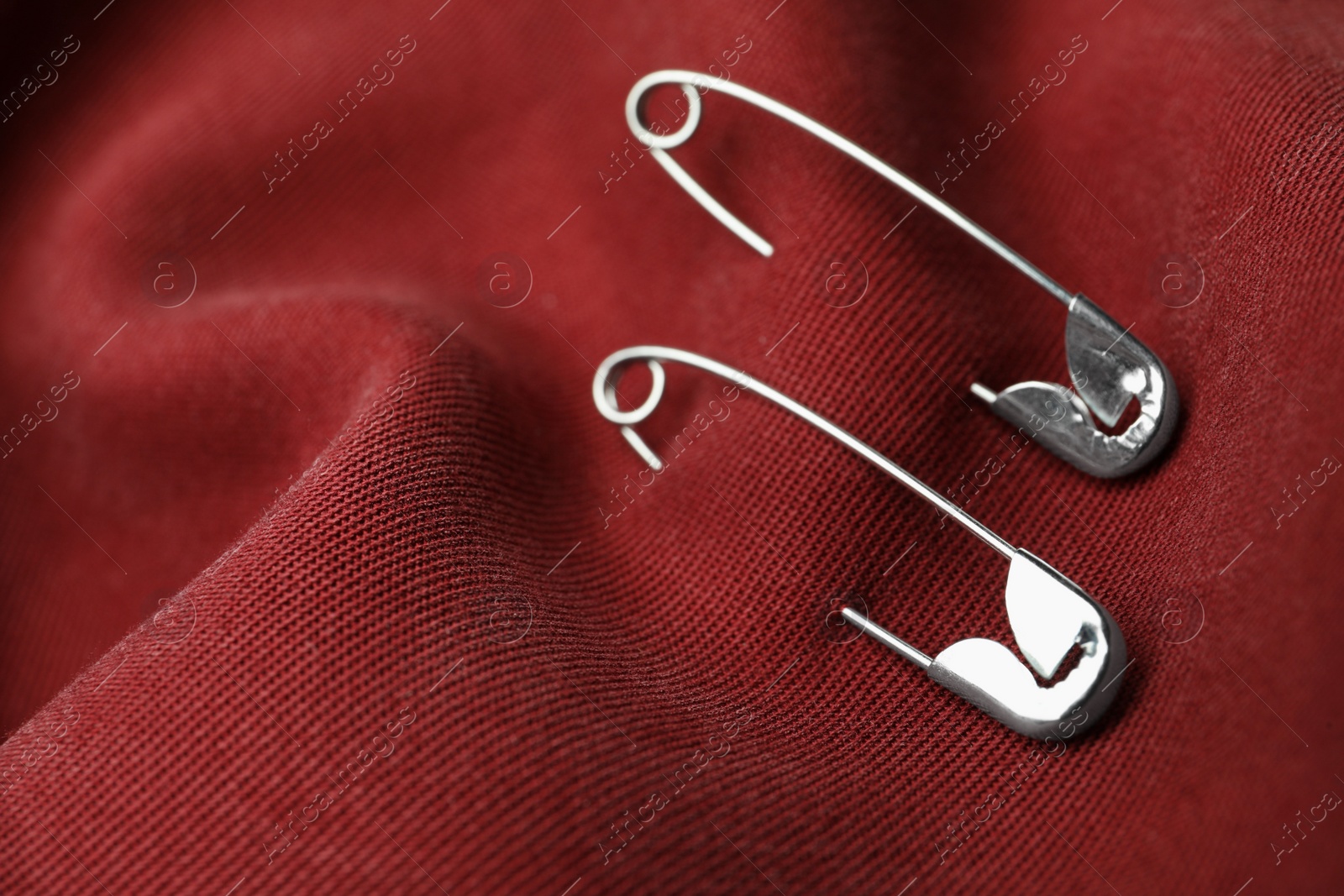 Photo of Closeup view of metal safety pins on clothing