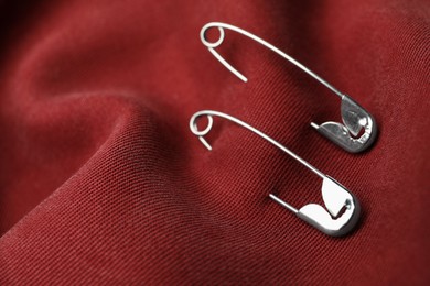 Closeup view of metal safety pins on clothing