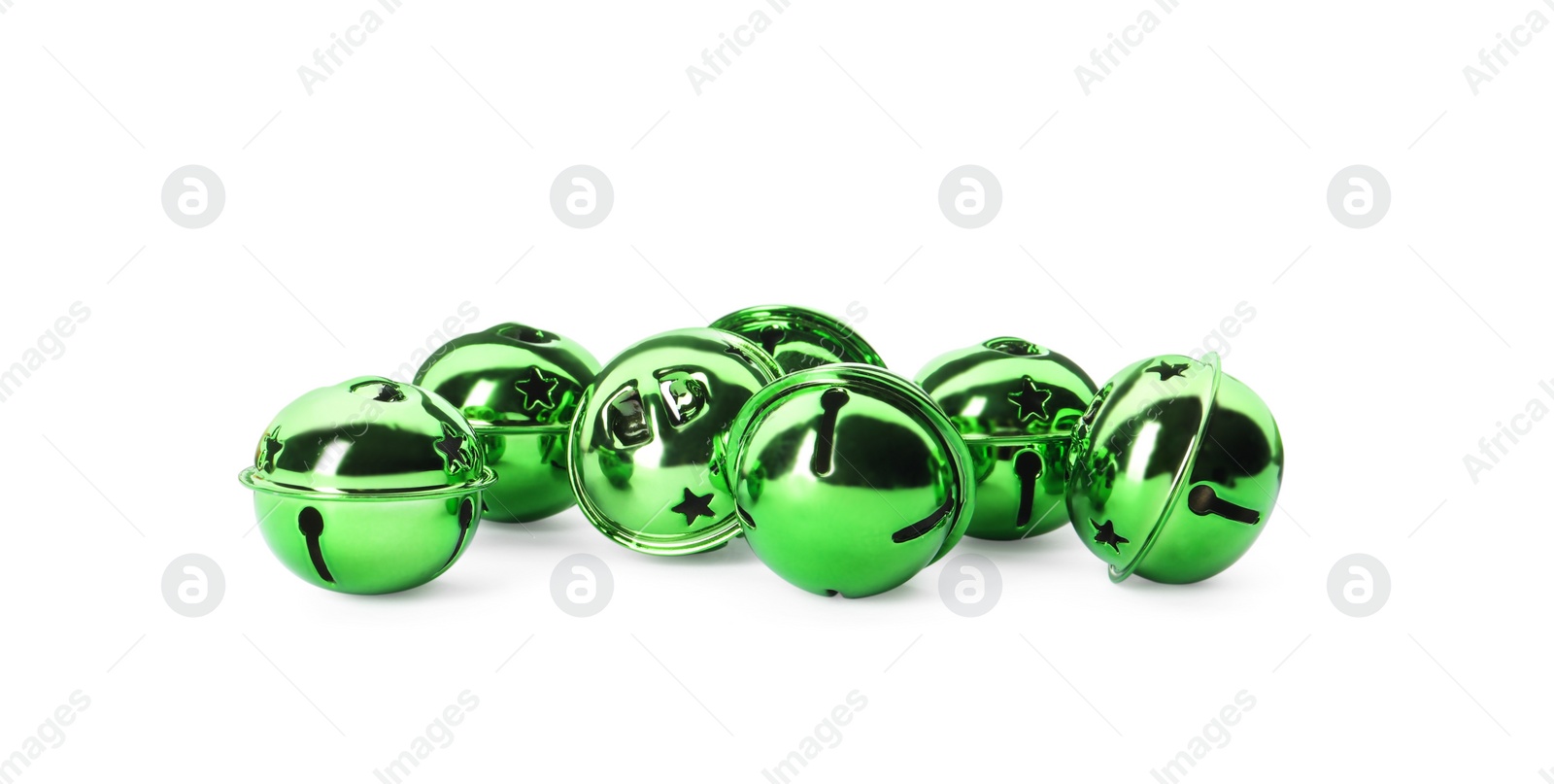 Photo of Shiny green sleigh bells on white background