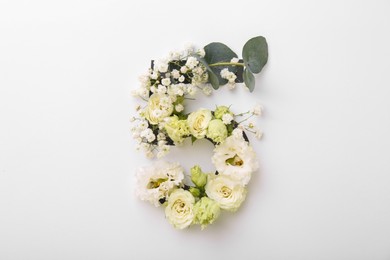 Photo of Number 5 made of beautiful flowers and eucalyptus leaves on white background, top view