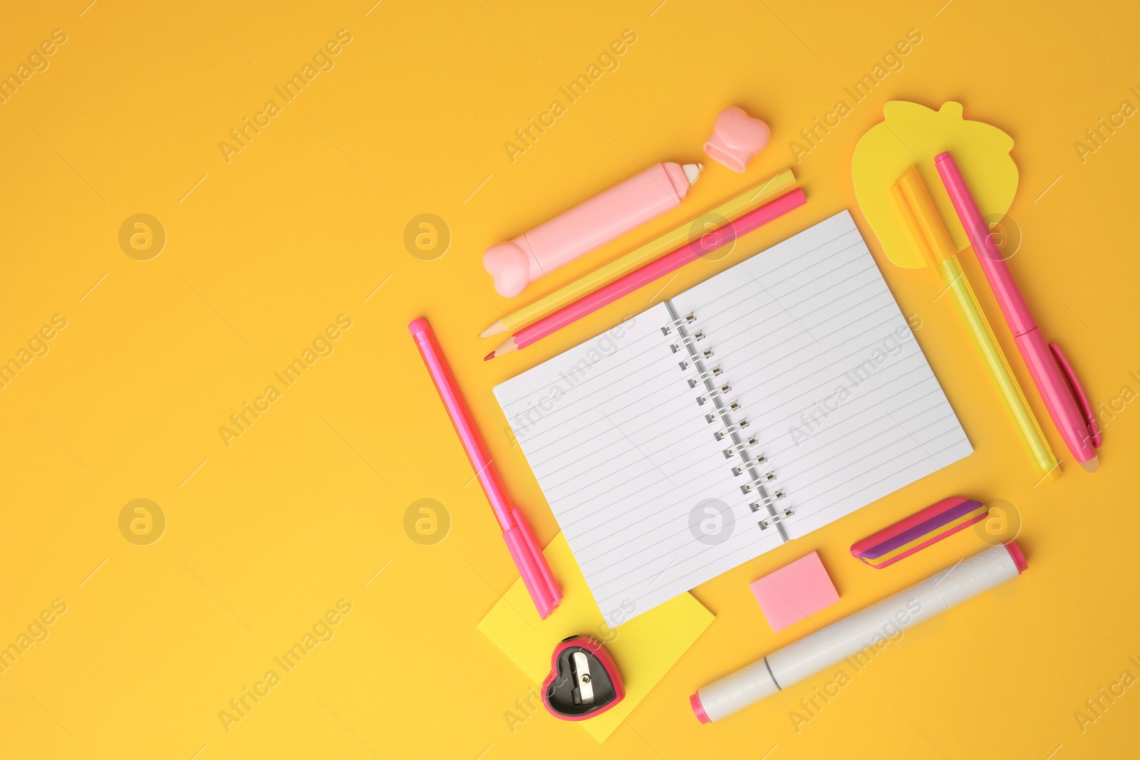 Photo of Flat lay composition with open notebook and different school stationery on yellow background, space for text. Back to school