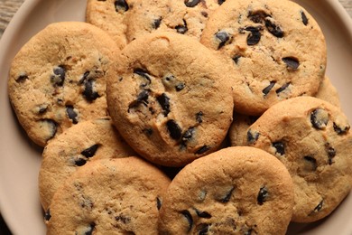 Photo of Delicious chocolate chip cookies on plate, top view