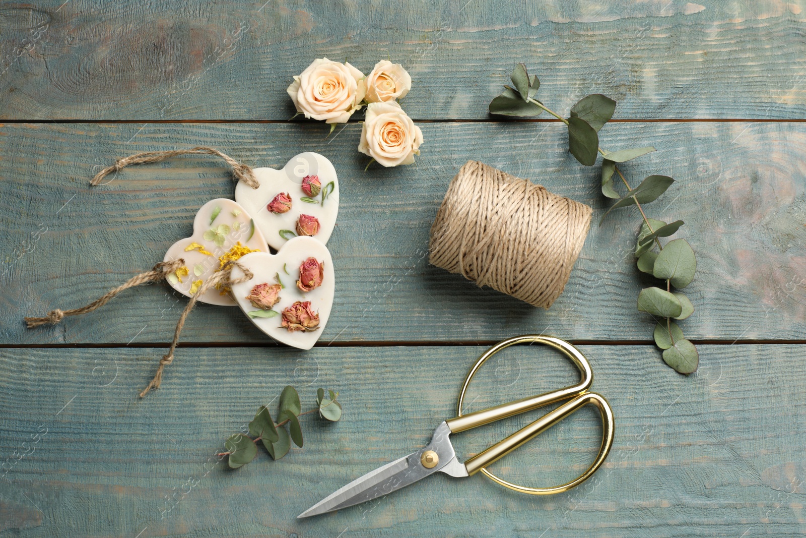 Photo of Flat lay composition with scented sachets on blue wooden table