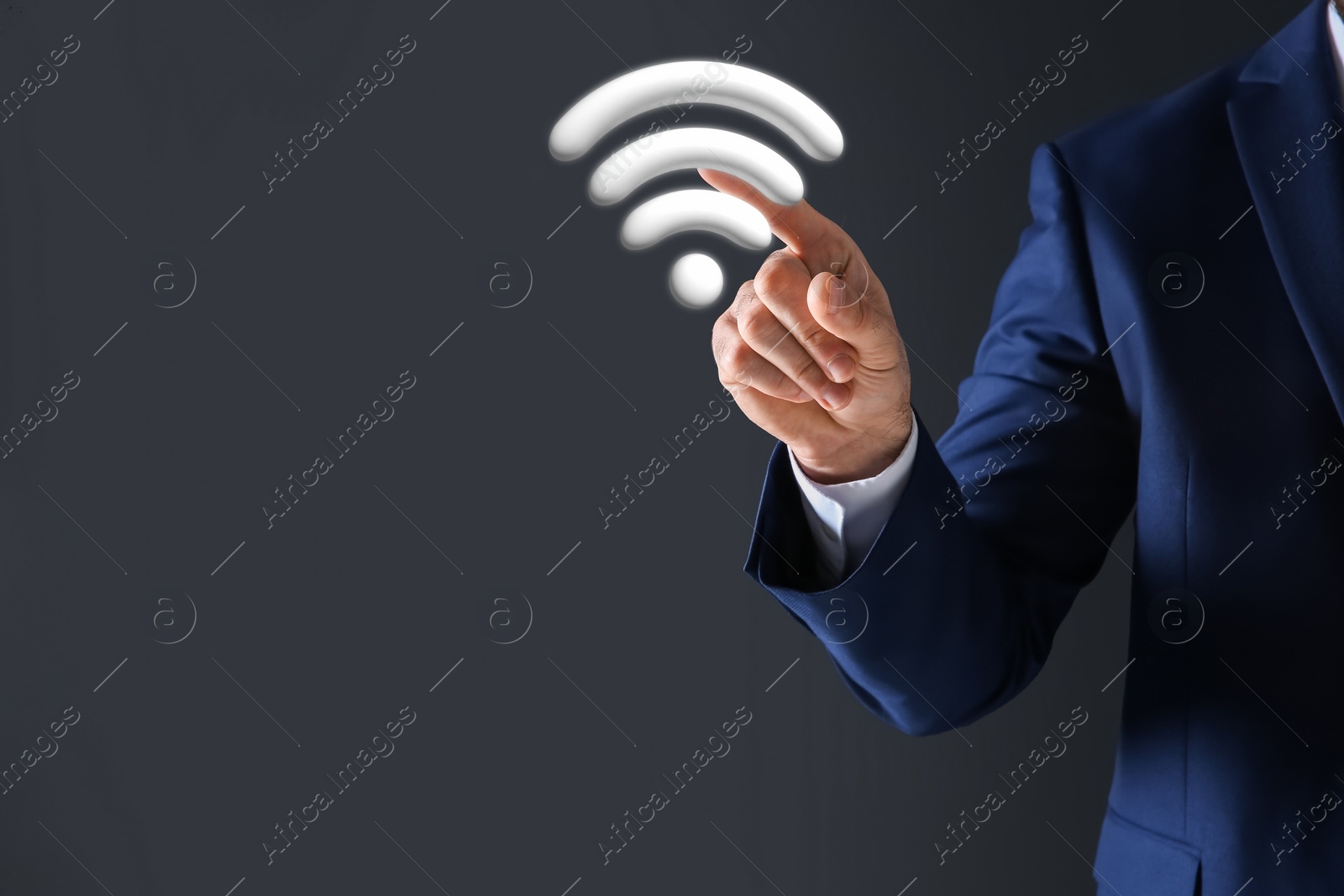 Image of Man touching Wi Fi symbol on digital screen against dark grey background, closeup