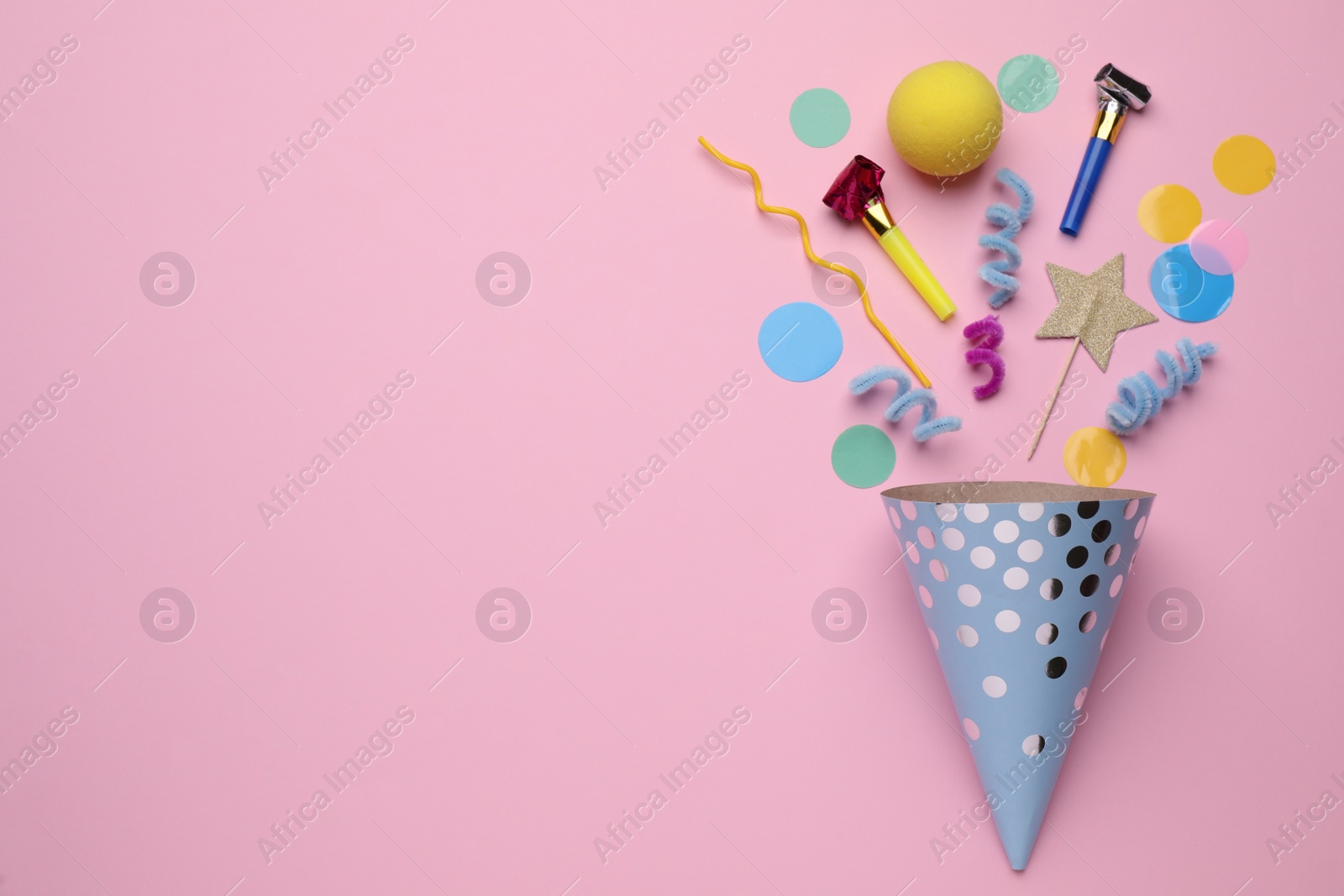 Photo of Party hat and different festive items on pink background, flat lay. Space for text