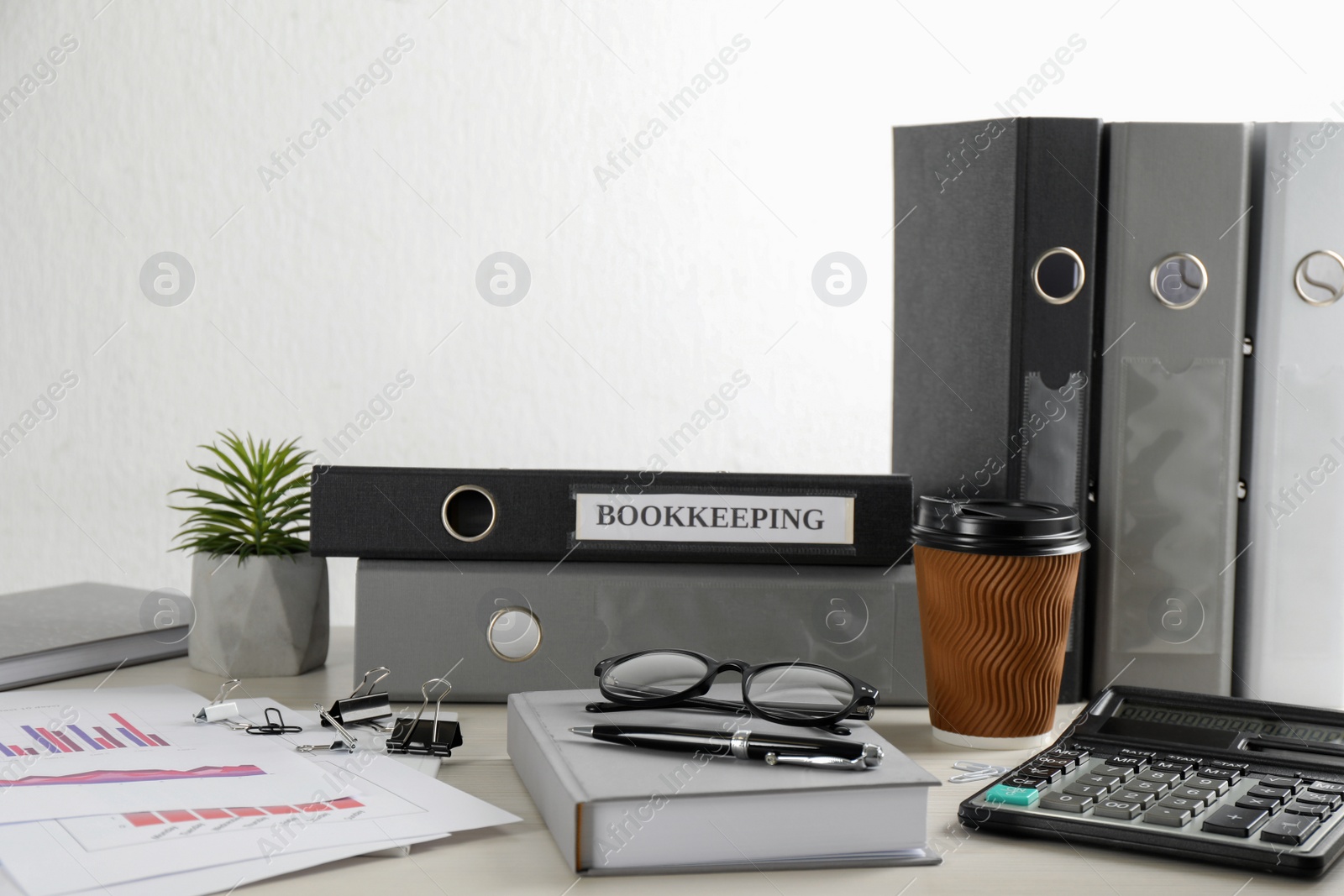 Photo of Bookkeeper's workplace with folders and documents on table