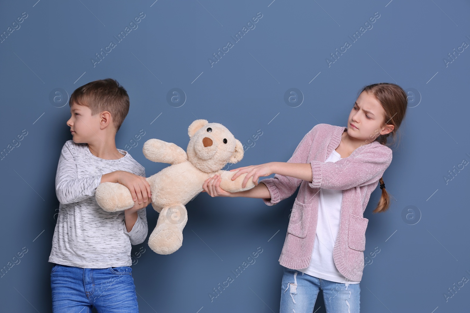 Photo of Brother arguing with sister on color background