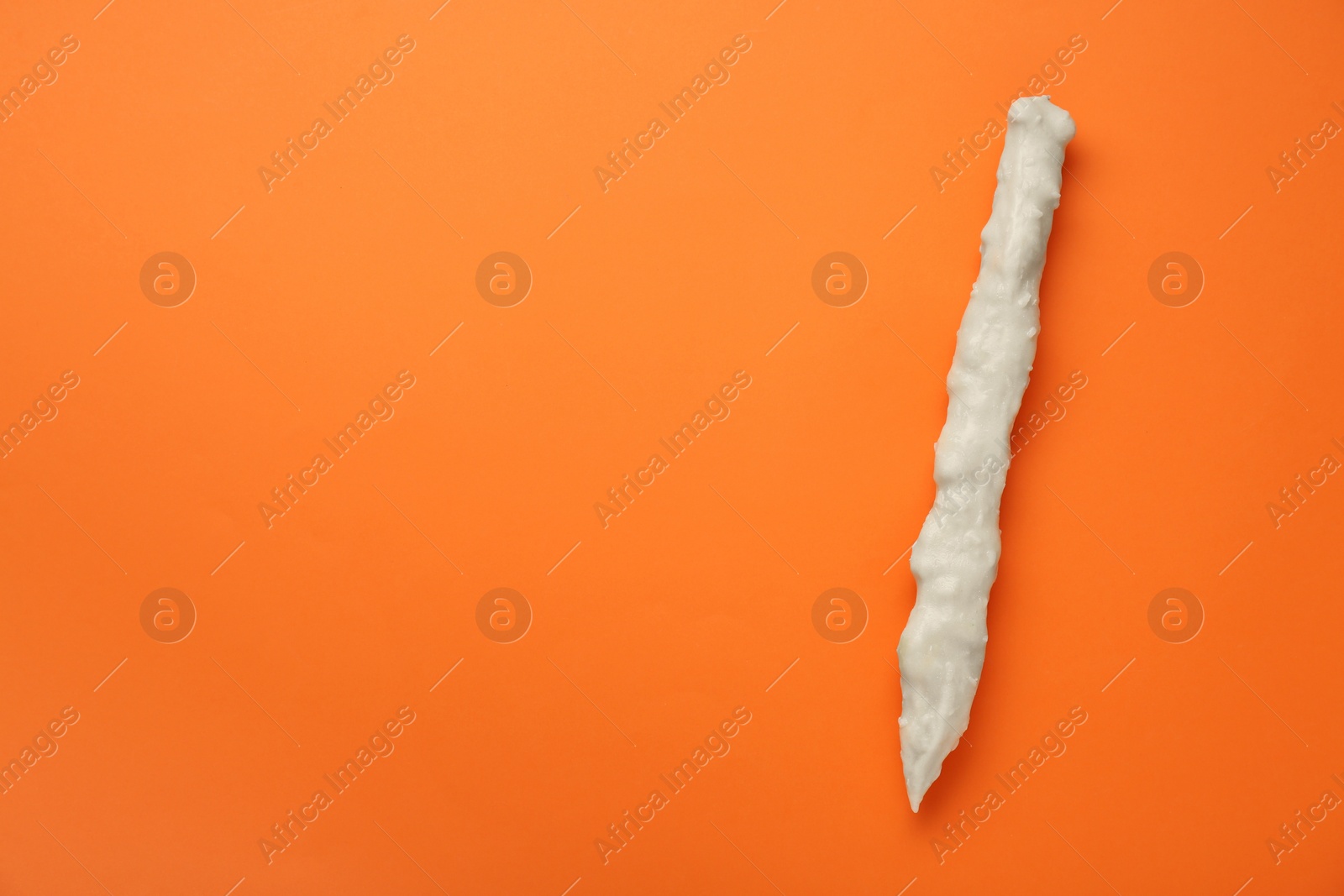 Photo of Delicious churchkhela on orange background, top view. Space for text