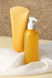 Photo of Bottle and tube of face cleansing products on table