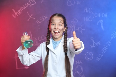 Photo of Emotional pupil holding Florence flask against blackboard with chemistry formulas