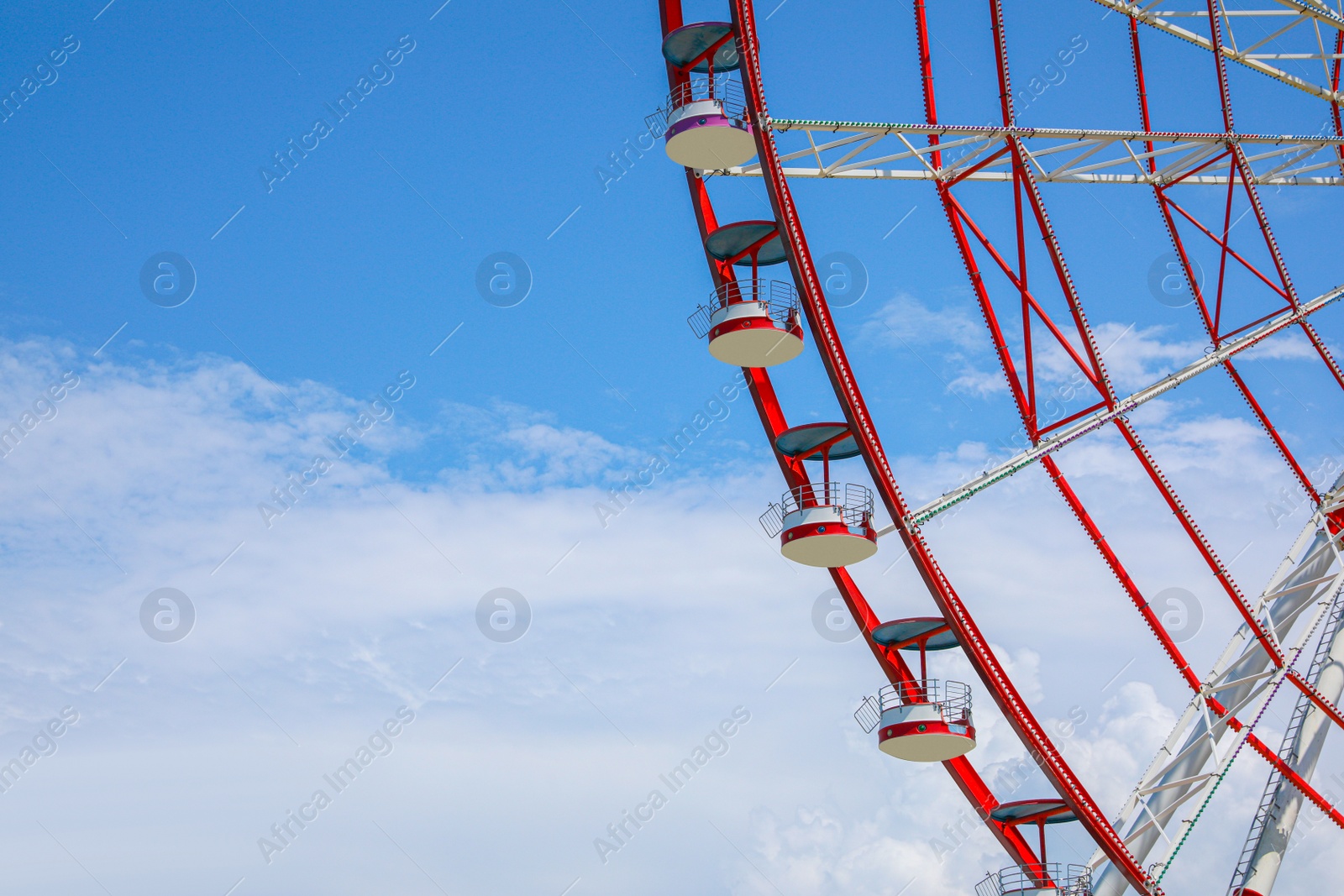 Photo of Beautiful large Ferris wheel against cloudy sky