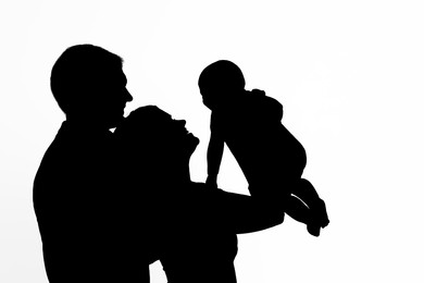 Image of Silhouette of family isolated on white Parents with baby