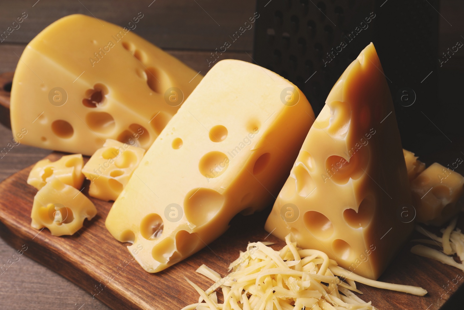 Photo of Tasty fresh cheese on wooden table, closeup