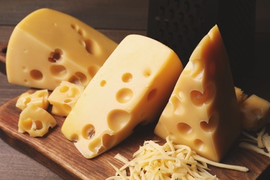 Photo of Tasty fresh cheese on wooden table, closeup