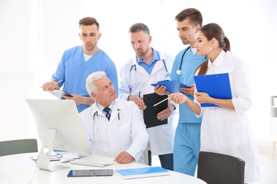 Photo of Group of doctors attending meeting in clinic. Cardiology conference