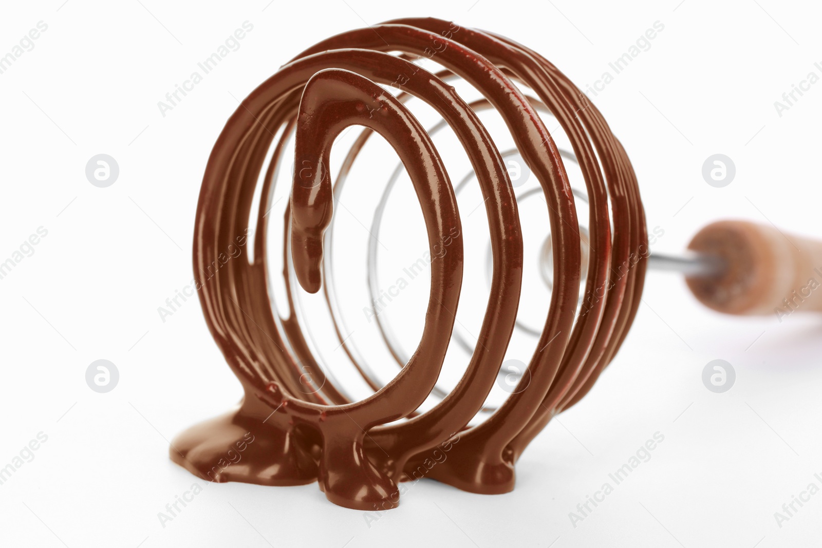 Photo of Whisk with chocolate cream isolated on white, closeup