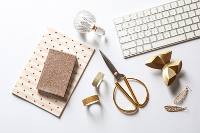 Composition with scissors, keyboard and notebooks on white background, top view