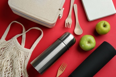 Photo of Flat lay composition with thermos on red background