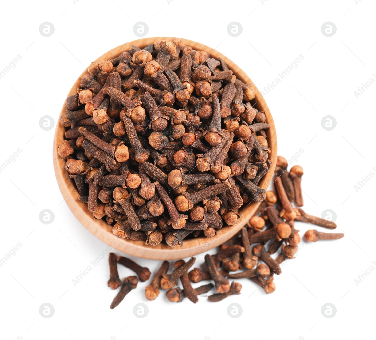 Photo of Aromatic dry cloves and wooden bowl on white background, top view