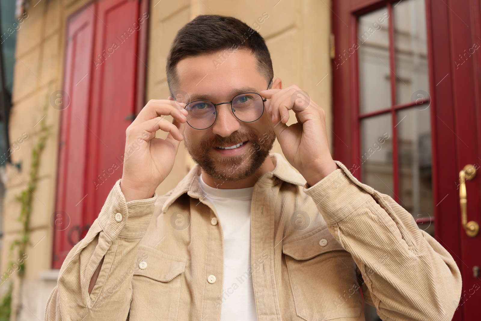 Photo of Portrait of handsome bearded man in glasses outdoors