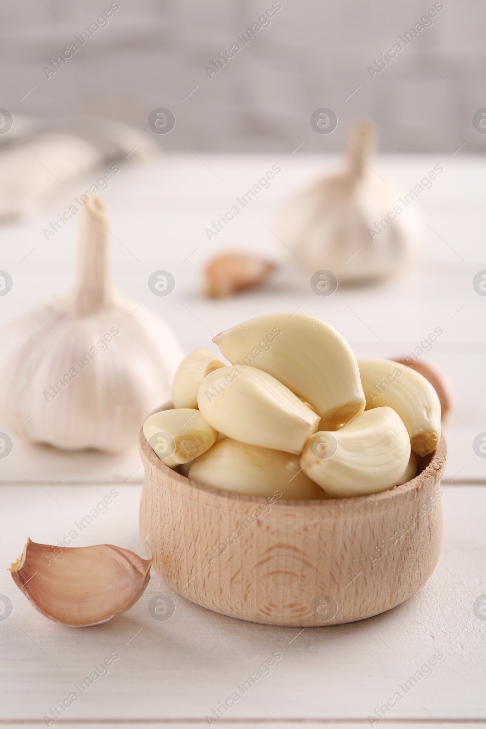 Photo of Fresh garlic on white wooden table, closeup