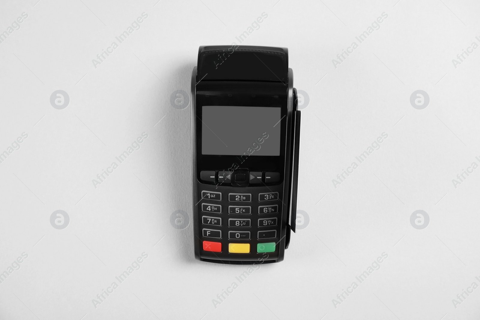 Photo of Modern payment terminal with credit card on grey background, top view
