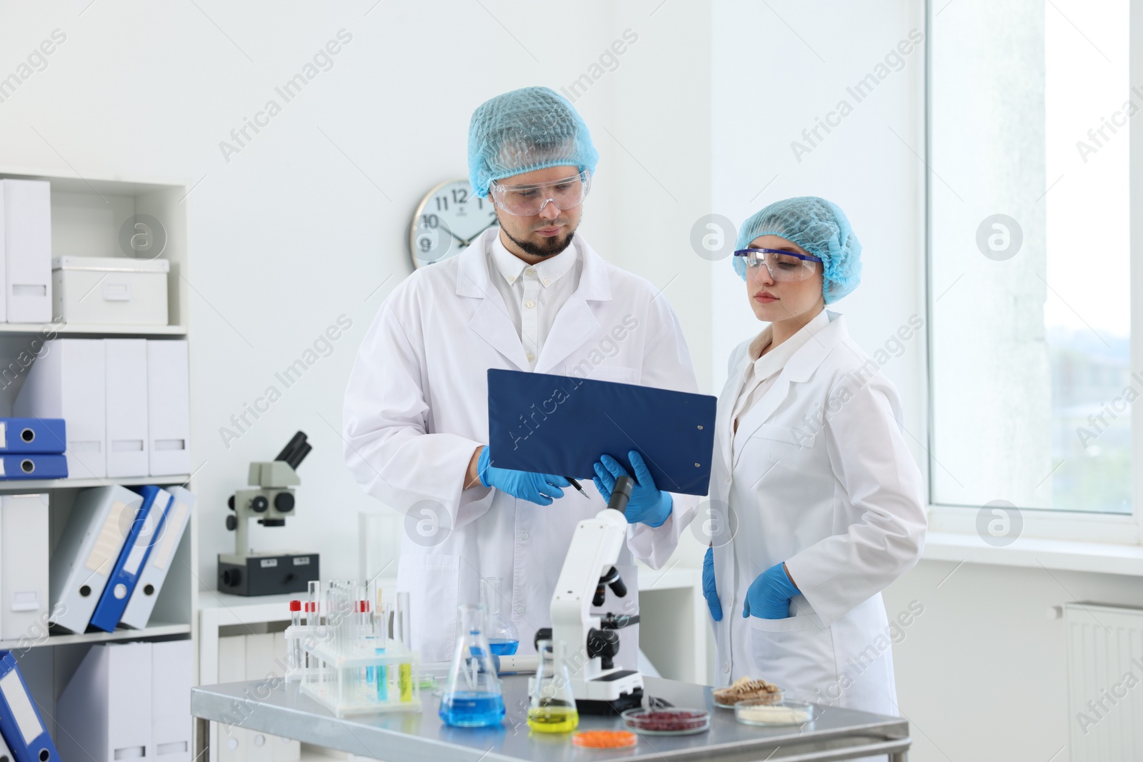 Photo of Quality control. Food inspectors checking safety of products in laboratory