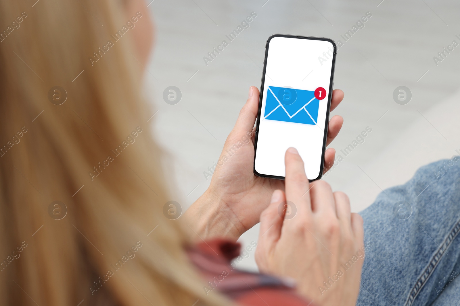Image of Woman checking new message on mobile phone, closeup