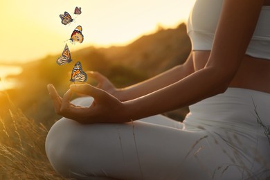 Woman meditating outdoors at sunset, closeup view