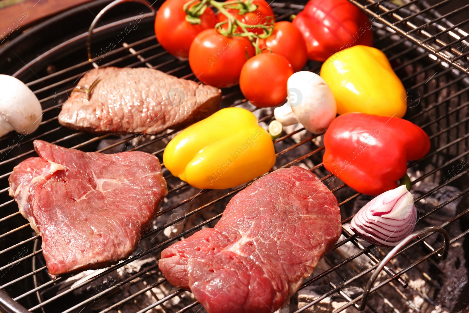 Photo of Modern grill with meat and vegetables outdoors, closeup