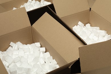 Open cardboard boxes with pieces of polystyrene foam. Packaging goods