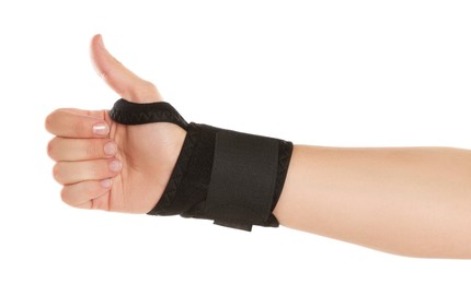 Woman with hand wrapped in medical bandage showing thumb up on white background, closeup