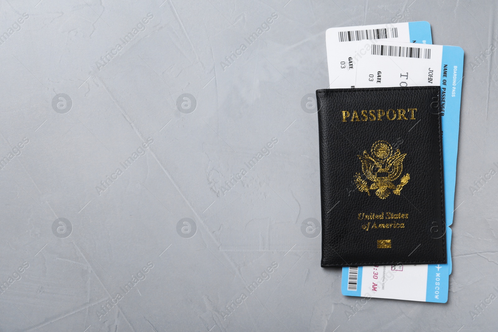 Photo of Passport with tickets on grey background, top view and space for text. Travel agency concept