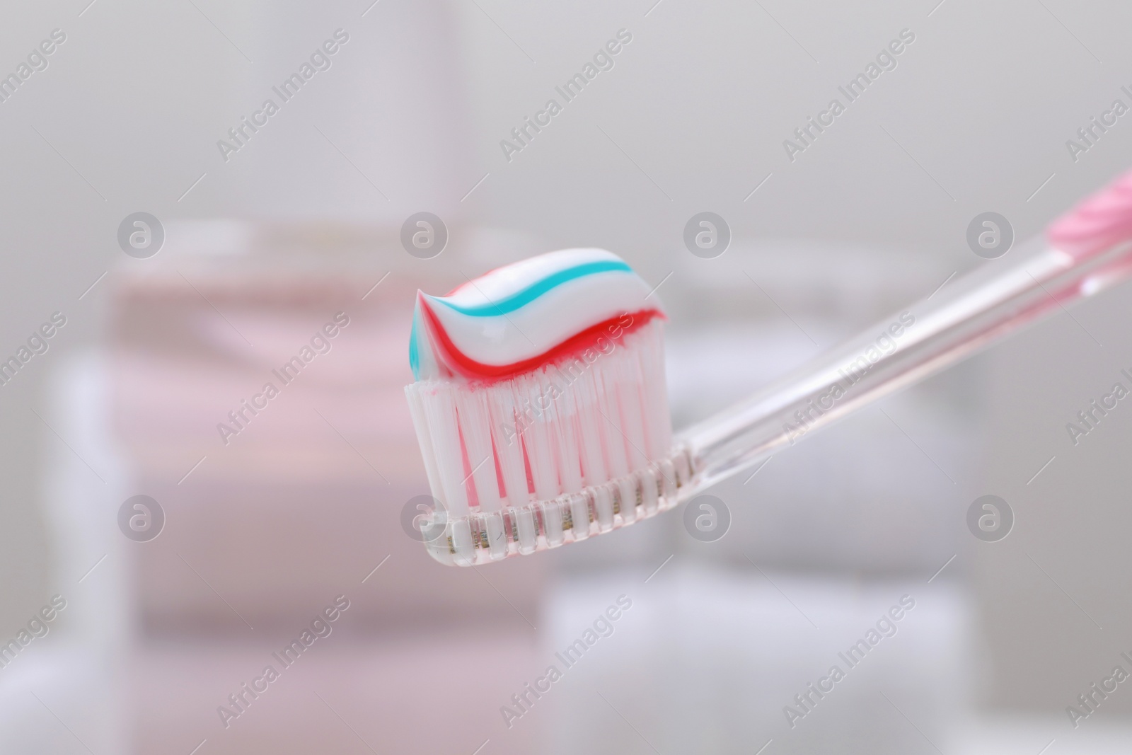 Photo of Toothbrush with paste on blurred background, closeup