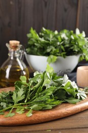 Photo of Fresh green parsley on wooden table, space for text