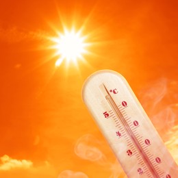 Image of Weather thermometer with high temperature outdoors on hot sunny day. Heat stroke warning