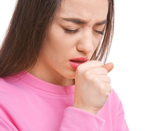 Young woman coughing on white background