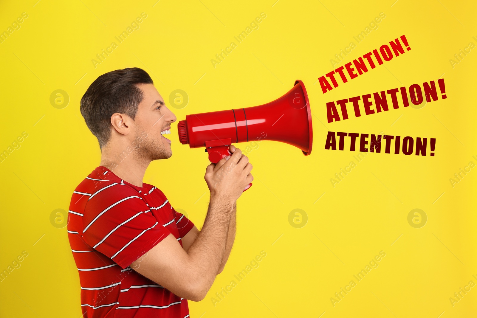 Image of Handsome man with megaphone on yellow background