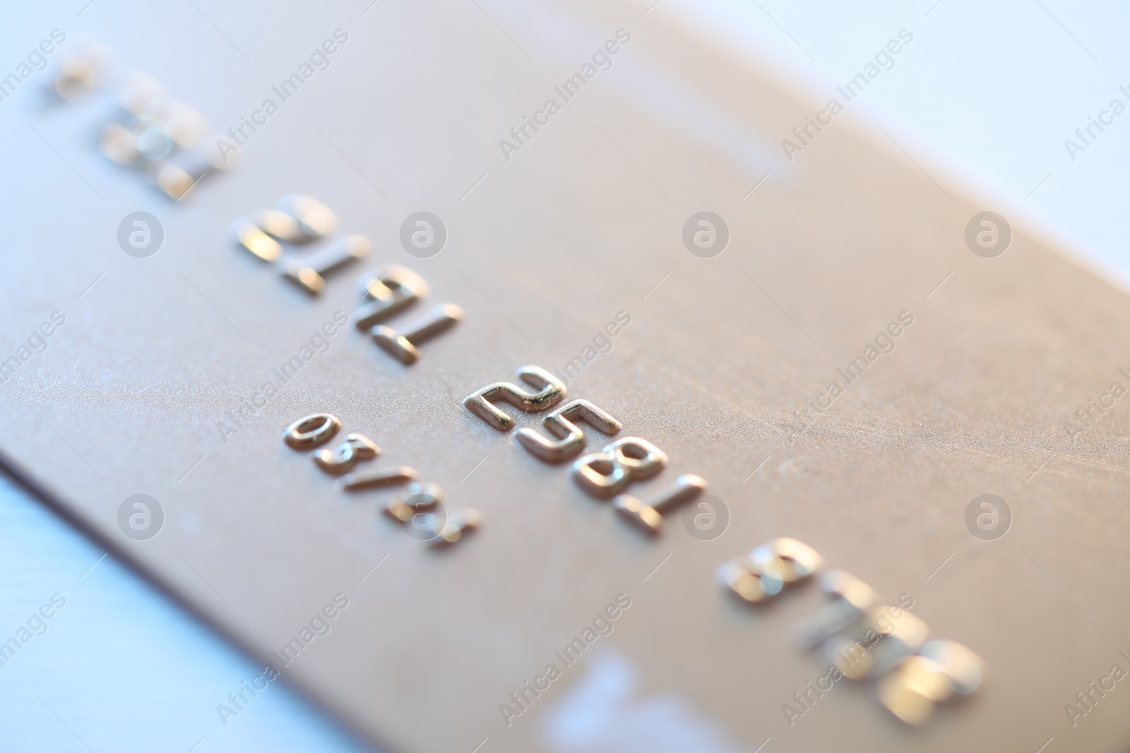 Photo of One credit card on light background, macro view