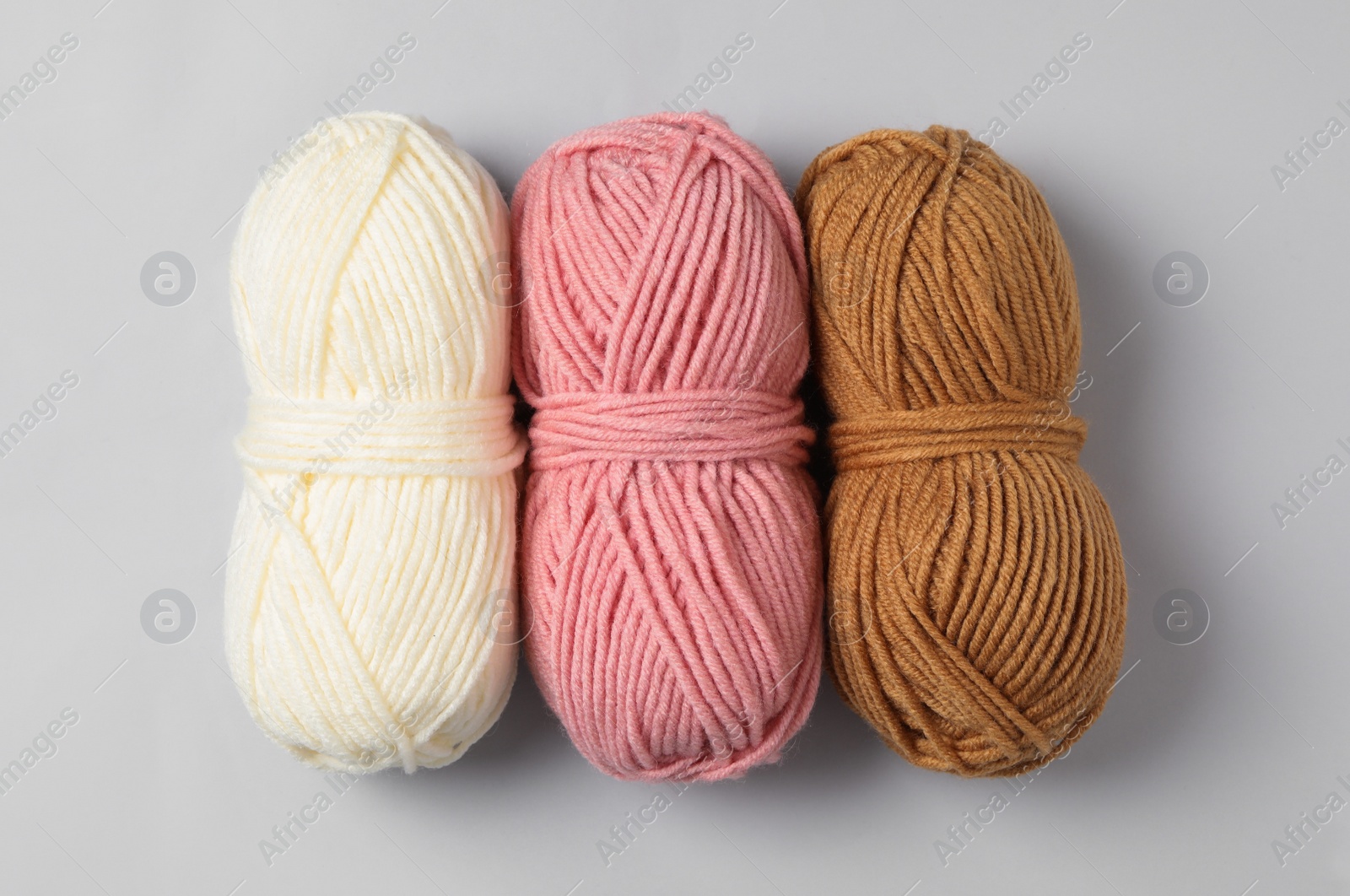 Photo of Soft woolen yarns on white background, flat lay