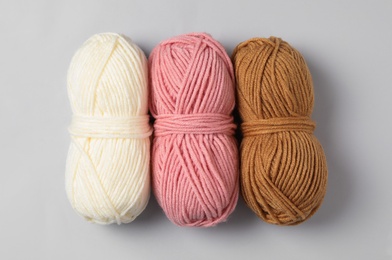 Photo of Soft woolen yarns on white background, flat lay