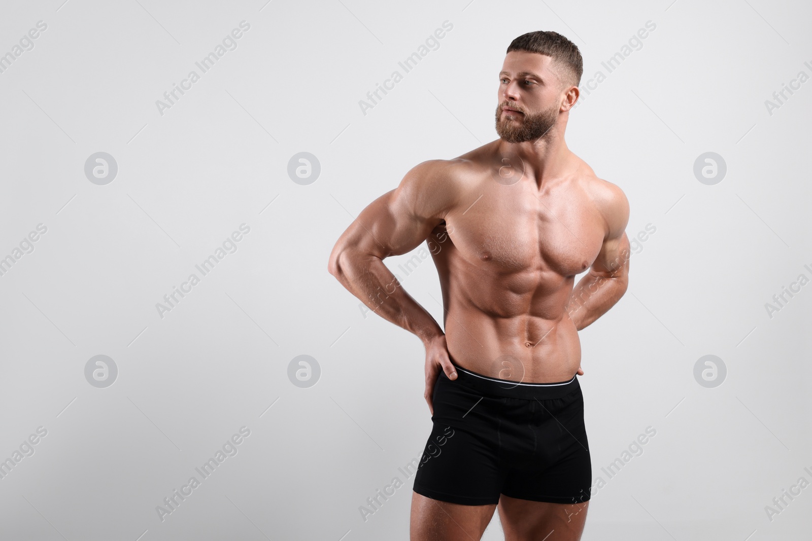 Photo of Young man is stylish black underwear on light grey background. Space for text